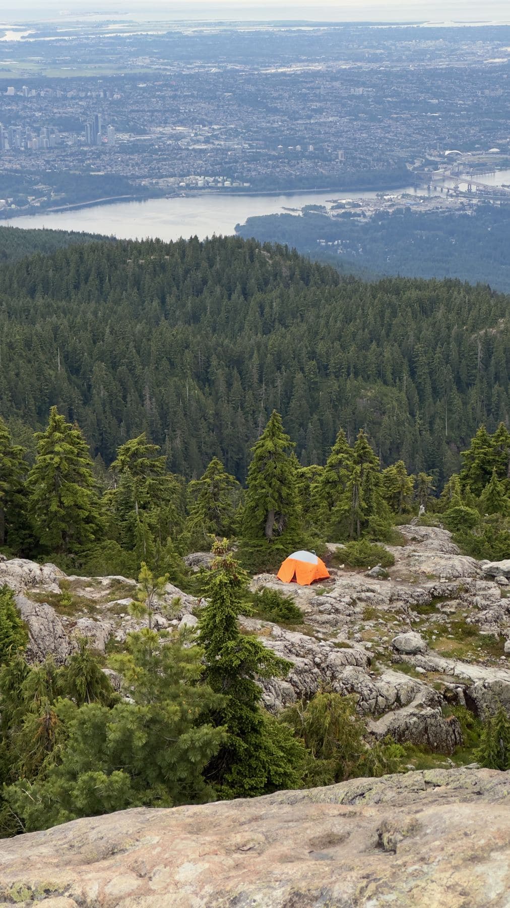 Orange tent on a granite ridge